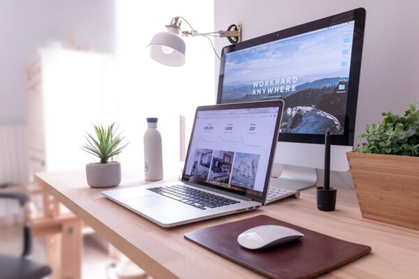 desktop and laptop displayed on a desk