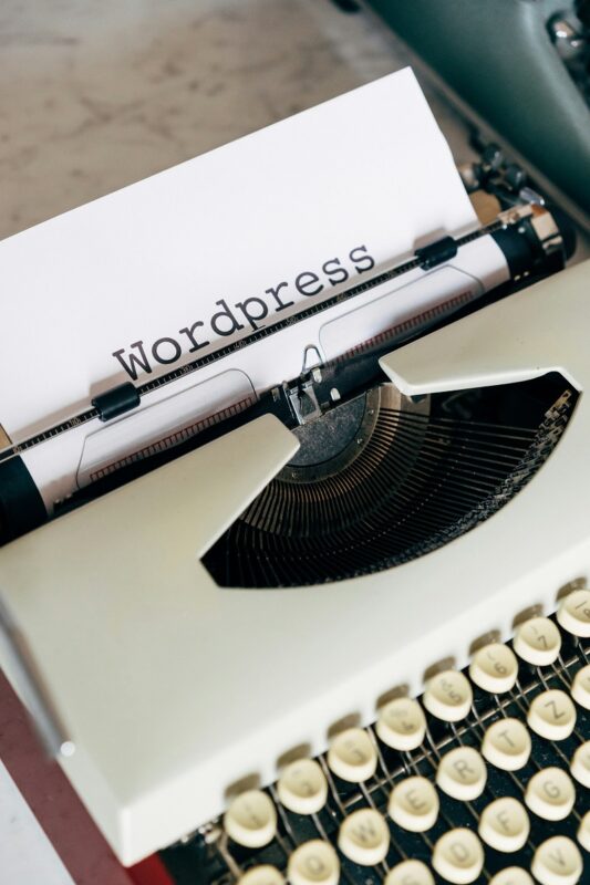 typewriter with the word WordPress on a piece of paper