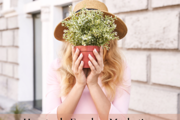 woman holding a flower pot in front of her face