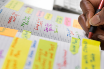 open desk calendar with bright sticky notes